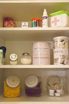 a shelf with jars and other items in a refrigerator at Quiet & Cosy Apt in the Heart of Old Cracow in Kraków