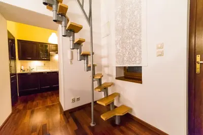 a room with a stair case in a kitchen at Quiet & Cosy Apt in the Heart of Old Cracow in Kraków