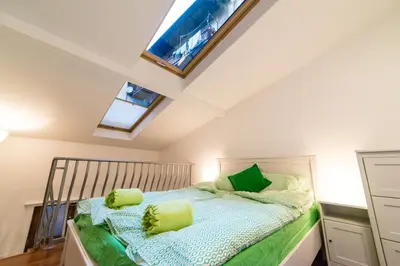 a bedroom with a bed with green pillows at Quiet & Cosy Apt in the Heart of Old Cracow in Kraków