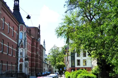 a city street with buildings and cars parked on the street at Apartament Arkadia na Kazimierzu in Kraków