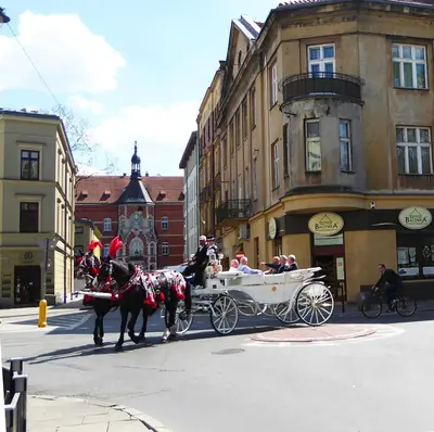 a horse drawn carriage on a city street at Apartament Arkadia na Kazimierzu in Kraków