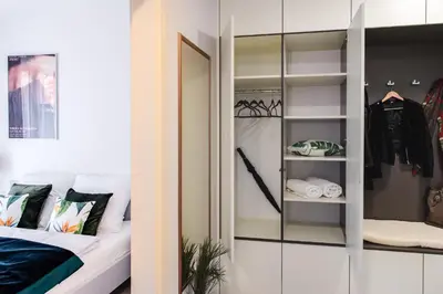 a room with a closet with a bed and a mirror at Apartament Arkadia na Kazimierzu in Kraków