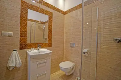 a bathroom with a toilet and a sink and a shower at Apartamenty Grodzka 8 in Kraków