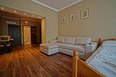 a living room with a couch and a bed at Apartamenty Grodzka 8 in Kraków