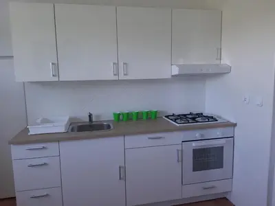 a white kitchen with a sink and a stove at Agroturystyka Wichrowe Wzgorze in Osiek