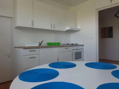 a kitchen with a table with blue circles on it at Agroturystyka Wichrowe Wzgorze in Osiek