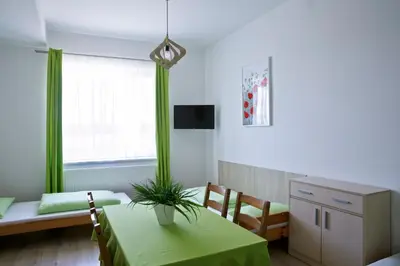 a room with a table with a plant on it at Agroturystyka Wichrowe Wzgorze in Osiek