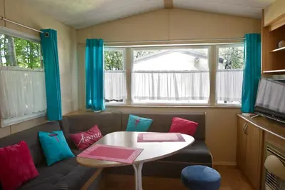 a small living room with a table and a couch at Agroturystyka Wichrowe Wzgorze in Osiek