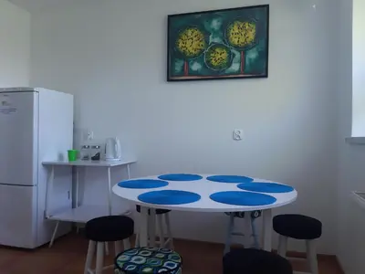 a kitchen with a table and stools in a room at Agroturystyka Wichrowe Wzgorze in Osiek