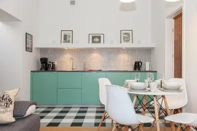 a kitchen with a table and chairs in a room at BC7 Apartments in Kraków