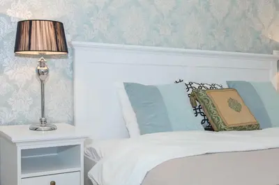 a bedroom with a bed with a lamp on a night stand at BC7 Apartments in Kraków
