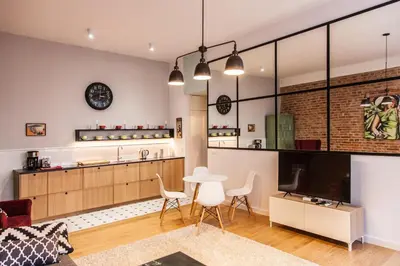 a kitchen and living room with a table and chairs at BC7 Apartments in Kraków