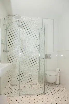 a glass shower in a bathroom with a toilet at BC7 Apartments in Kraków