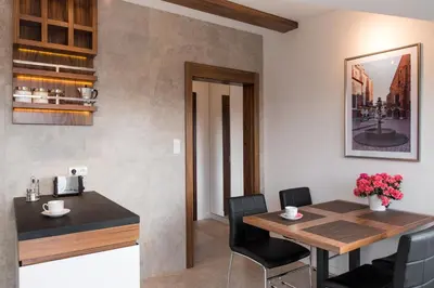 a kitchen and dining room with a table and chairs at Apartament nad dachami Krakowa in Kraków