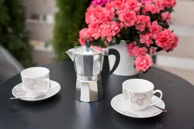 a black table with two coffee cups and a pitcher at Apartament nad dachami Krakowa in Kraków