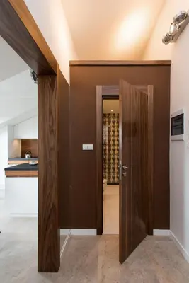 a door leading into a kitchen with a wine cellar at Apartament nad dachami Krakowa in Kraków