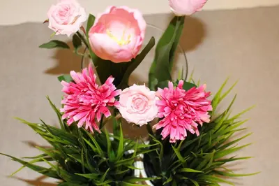 a vase with pink flowers in it at Przy Mocaku II in Kraków