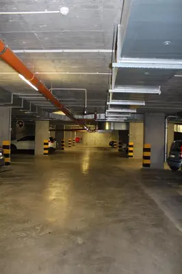 an empty parking garage with cars parked in it at Przy Mocaku II in Kraków