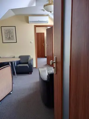 an open door to a room with a table and chairs at Aparthotel W Pałacu in Kraków