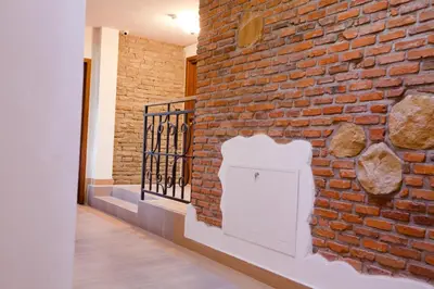 a brick wall with a white mailbox on it at Aparthotel W Pałacu in Kraków