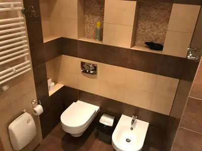 a bathroom with a toilet and a sink at Apartments Poland Kazimierz in Kraków