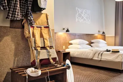 a hotel room with a bed and a skateboard on a table at Daniel Griffin Aparthotel by Artery Hotels in Kraków