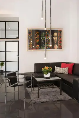 a living room with a black couch and a table at Art Room Boutique Apartment in Kraków