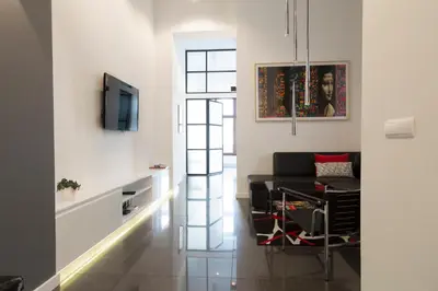 a living room with a couch and a tv at Art Room Boutique Apartment in Kraków