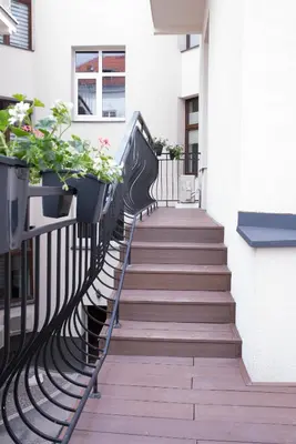 a stairway with potted plants on the side of a building at Art Room Boutique Apartment in Kraków