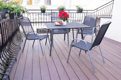 a table and chairs on a balcony with flowers at Art Room Boutique Apartment in Kraków