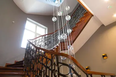 a chandelier hanging from the stairs in a house at Art Room Boutique Apartment in Kraków