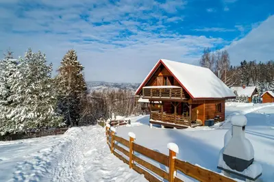 a log cabin in the snow with a fence at U Kazika w górach in Ślemień