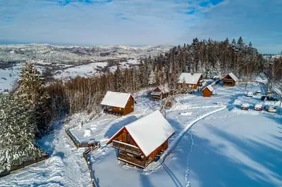 an aerial view of a snow covered cabin at U Kazika w górach in Ślemień