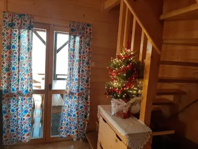 a christmas tree in a room with a staircase at U Kazika w górach in Ślemień