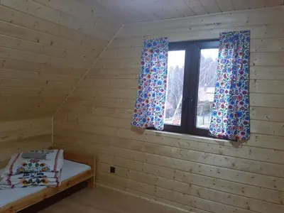 a room with a bed and a window at U Kazika w górach in Ślemień
