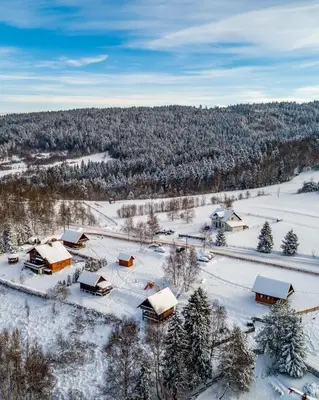an aerial view of a village covered in snow at U Kazika w górach in Ślemień