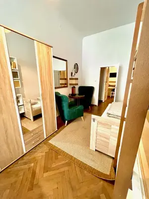 a living room with a mirror and a bedroom at Pokoje Gościnne Wiślna in Kraków