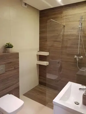 a bathroom with a shower and a toilet and a sink at Jack Apartment in Kraków