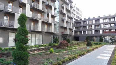 an apartment building with a garden in front of it at Jack Apartment in Kraków
