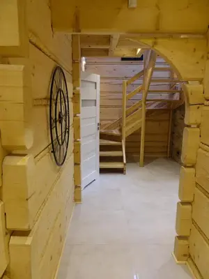 a room with wooden walls and a door and stairs at Domki Zawoja z Jacuzzi in Zawoja