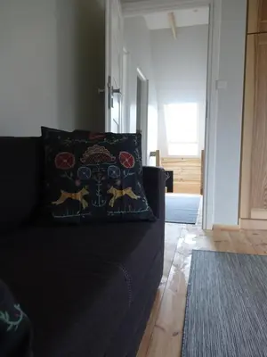 a black couch with a pillow on it in a living room at Domki Zawoja z Jacuzzi in Zawoja