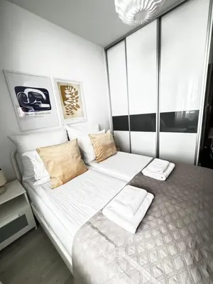a bedroom with a large bed with white sheets and pillows at InPoint One Bedroom Apartment with Balcony Self Check-In near Vistula River&Tauron Arena in Kraków