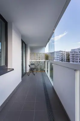 an empty balcony with a view of a building at InPoint One Bedroom Apartment with Balcony Self Check-In near Vistula River&Tauron Arena in Kraków