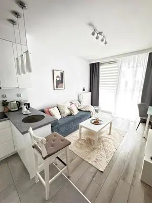 a living room with a couch and a table at InPoint One Bedroom Apartment with Balcony Self Check-In near Vistula River&Tauron Arena in Kraków