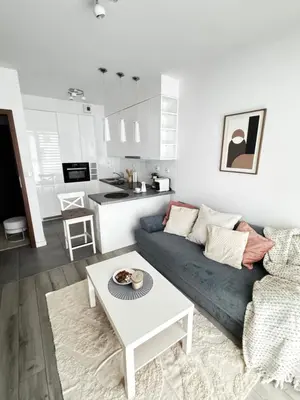 a living room with a couch and a table at InPoint One Bedroom Apartment with Balcony Self Check-In near Vistula River&Tauron Arena in Kraków