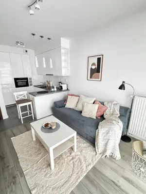 a living room with a blue couch and a table at InPoint One Bedroom Apartment with Balcony Self Check-In near Vistula River&Tauron Arena in Kraków