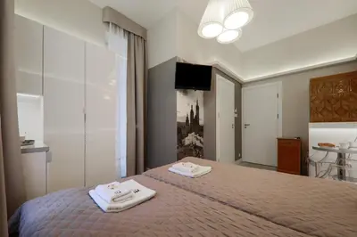 a bedroom with a bed with two towels on it at Apartamenty Podwale in Kraków
