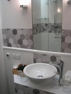 a bathroom with a sink and a mirror at Apartamenty Podwale in Kraków