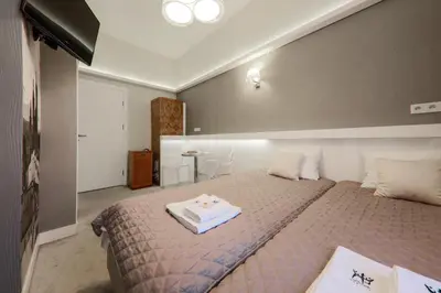 a bedroom with a large bed with a tray on it at Apartamenty Podwale in Kraków