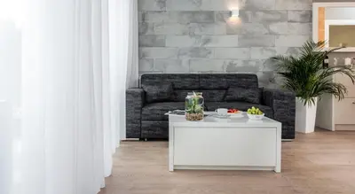 a living room with a couch and a table at Ariańska Apartment - lift & AC in Kraków